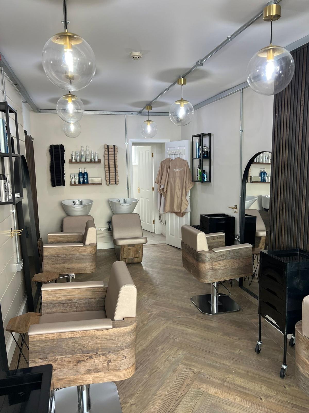 Commercial salon fit-out with herringbone flooring and globe pendants