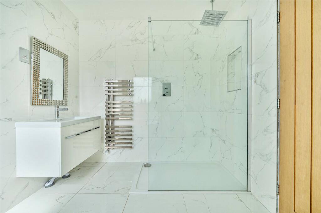 Walk-in marble shower with brass fittings
