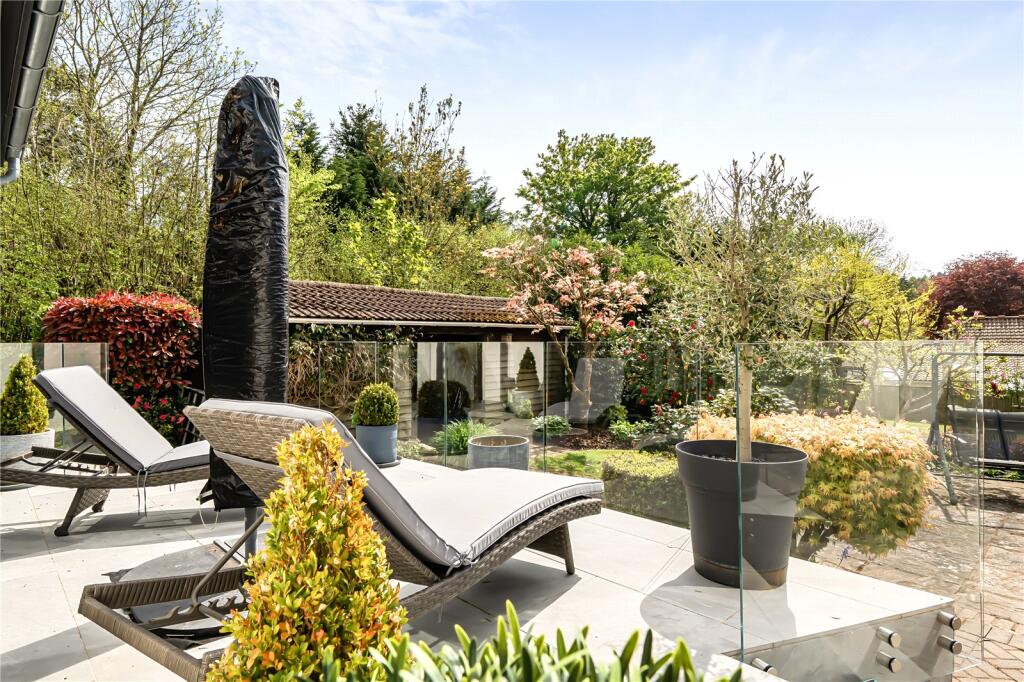 Landscaped private garden with seating and sun loungers